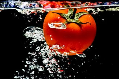 Tomato water splash Stock Photos