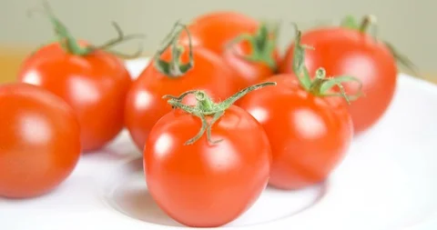 Tomato on a white plate Stock Footage 101456755