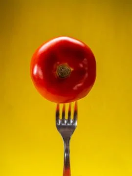 Tomato with yellow background Stock Photos
