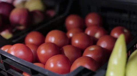 Tomatoes and apples in a grocery store Stock Footage