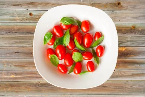Tomatoes and basil Stock Photos