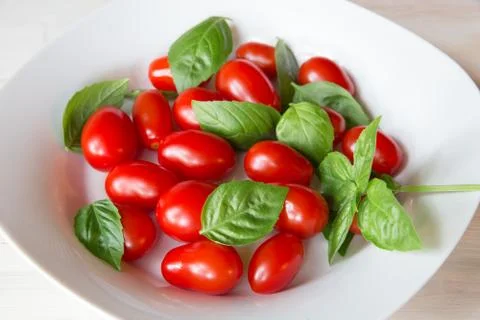Tomatoes and basil Stock Photos