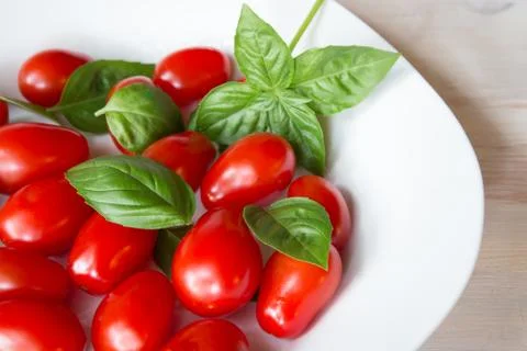 Tomatoes and basil Stock Photos