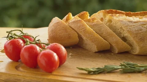 Tomatoes and bread on a cutting board Stock Footage 135884957