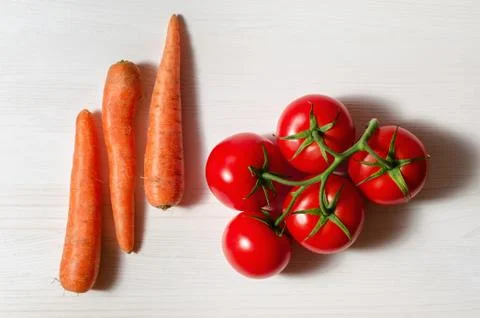 Tomatoes and carrots Stock Photos