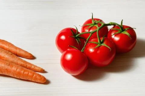 Tomatoes and carrots Stock Photos