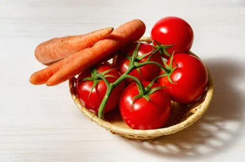 Tomatoes and carrots Stock Photos