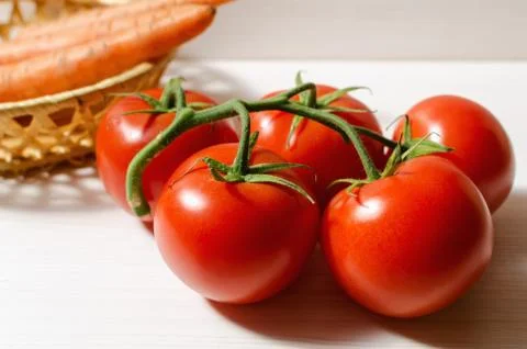 Tomatoes and carrots Stock Photos