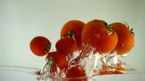 Tomatoes and cherry tomatoes in water. Slow motion. Stock-Footage 105425612