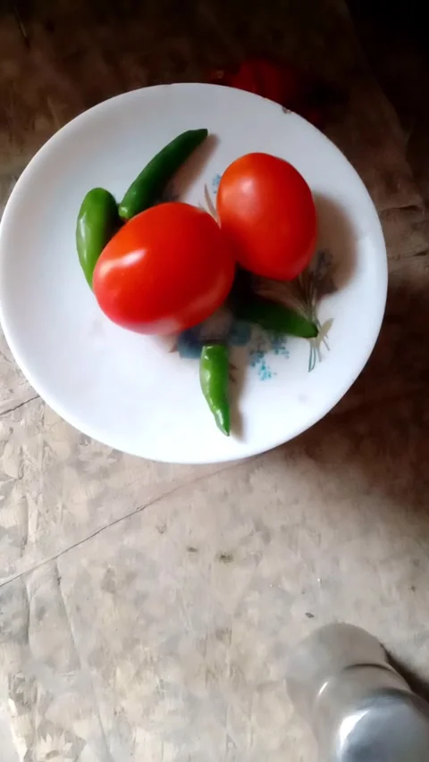 Tomatoes and chili on the plate Stock Footage 323578630