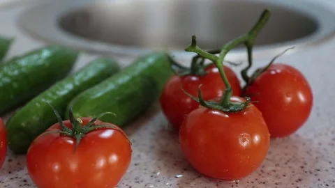 Tomatoes and cucumbers on the kitchen table. The shallow pull Video stock 125973672