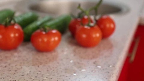 Tomatoes and cucumbers on the kitchen table. The shallow pull 動画素材 125973686