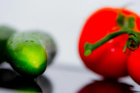 Tomatoes and cucumbers on the kitchen table Stock Photos