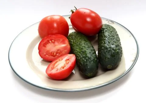 Tomatoes and cucumbers. Stock Photos