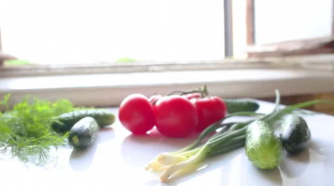 Tomatoes and cucumbers on the table in kitchen Vídeo Stock 40175216