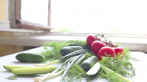 Tomatoes and cucumbers on the table in kitchen Видео 40175314