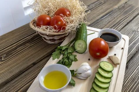 Tomatoes and cucumbers on the table, olive oil and balsamic vinegar, garlic, Stock Photos