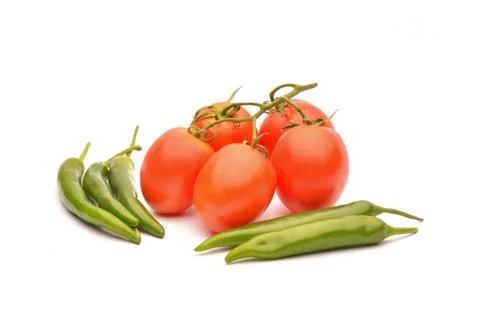 Tomatoes and hot chilli on background Stock Photos