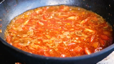 Tomatoes and pork chops in red curry paste in pan (Nam Prik Ong).  Video stock 138334017