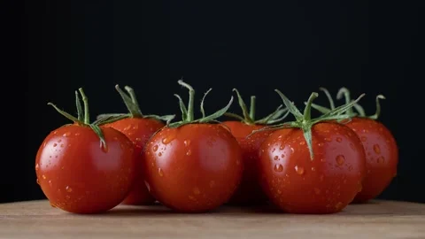Tomatoes appear one at a time on a black background. Stop motion animation. Stock-Footage 151680433