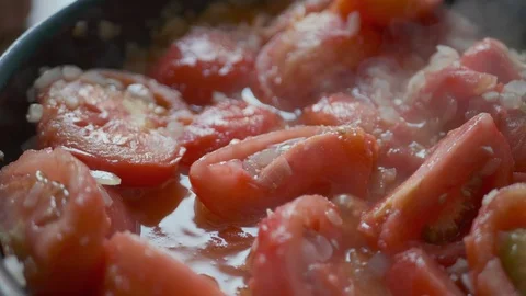 Tomatoes are boiling in the pan with the vegetables. Homemade tomato sauce recip Stock Footage 113828825