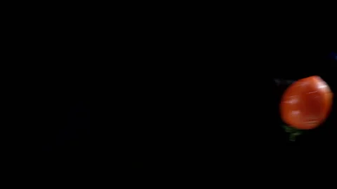 Tomatoes are falling in slow motion on a wet black Stock Footage 133222550