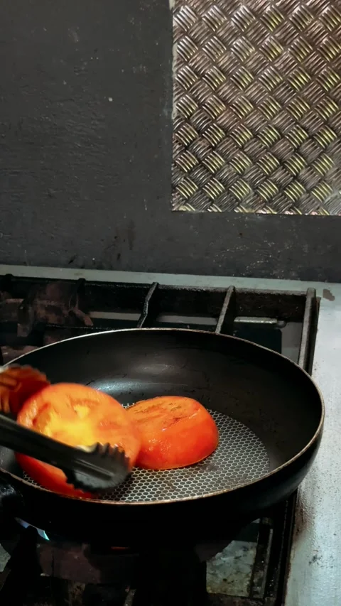 Tomatoes are fried in a pan Video stock 325452906