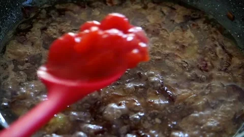 Tomatoes Being Added To Caremlised Fried Onions, London, UK Stock Footage 133194580