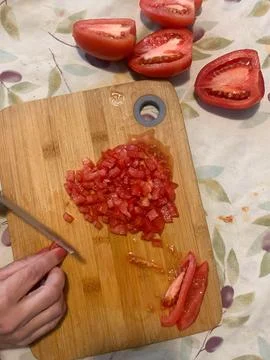 Tomatoes being cut Stock Photos