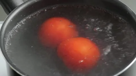The tomatoes being removed from the boiling water Video stock 24673202