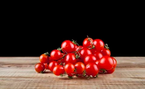 Tomatoes on a black background closeup Stock Photos