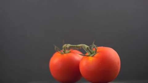 Tomatoes on a black background Stock-Footage 134915925