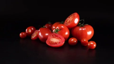 Tomatoes on black background, panning Video stock 75780773