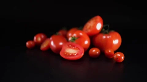 Tomatoes on black background, panning, shallow Depth of field Video stock 75781956