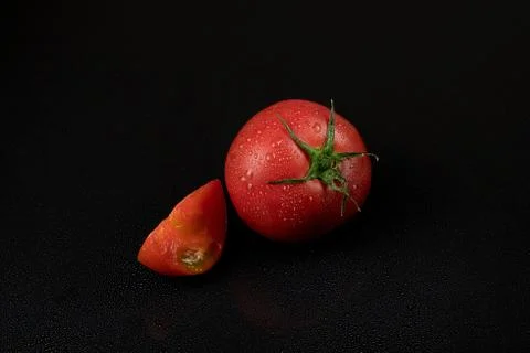 Tomatoes on a black background Stock Photos