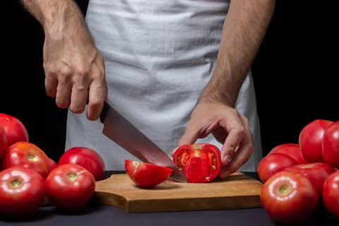 Tomatoes on a black background. Stock Photos
