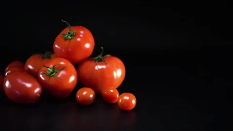 Tomatoes on black background, sliding, shallow Depth of field Video stock 75779586