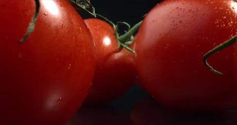 Tomatoes on black table close up. Footage of ripe tomatoes. Video stock 143171184