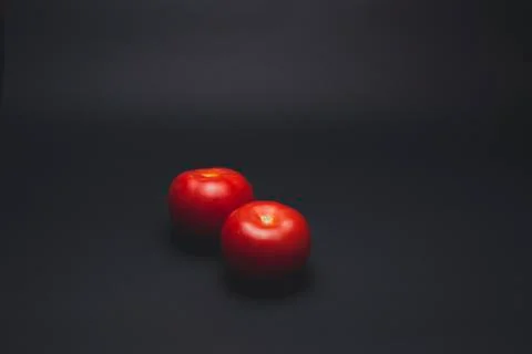 Tomatoes on a black table 스톡 사진