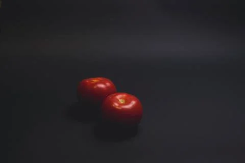 Tomatoes on a black table 스톡 사진
