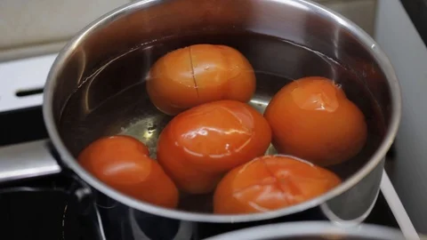 Tomatoes in the boiling water Stock Footage 121118748