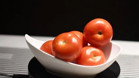 Tomatoes in a bowl Stock Photos