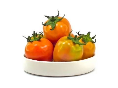 Tomatoes in ceramic plate. Stock Photos