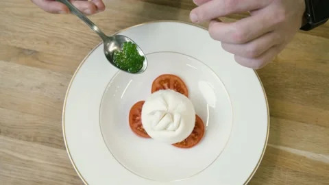 Tomatoes cheese and basil caviar on a plate Stockbeeldmateriaal 148499714