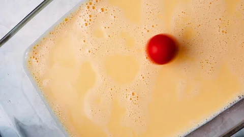 Tomatoes cherry added in omelet into a baking dish, top view. Slow motion hom Stock Footage 119957383