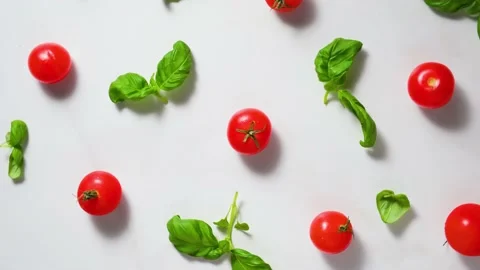 Tomatoes cherry and basil leaves on white background. Top view Stock Footage 150145976