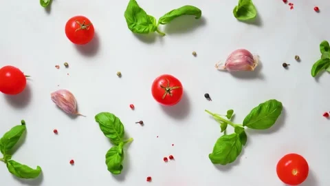 Tomatoes cherry, basil, garlic and pepper on white background. Top view Stock Footage 150145985