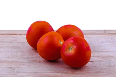 Tomatoes on chopping board closeup Stock Photos