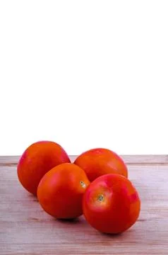 Tomatoes on chopping board Stock Photos