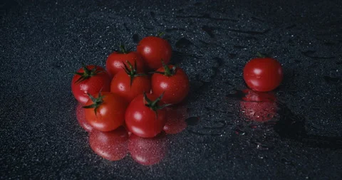 Tomatoes closeup falling in water with Splash droplets on black background macro Stock Footage 142235663